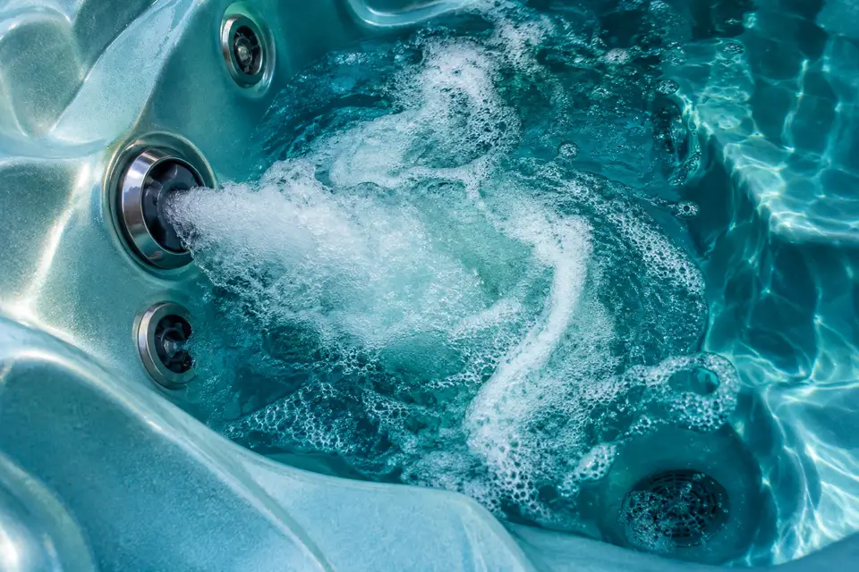 Foam and cleaning solution swirling in a spa footwell during a flush